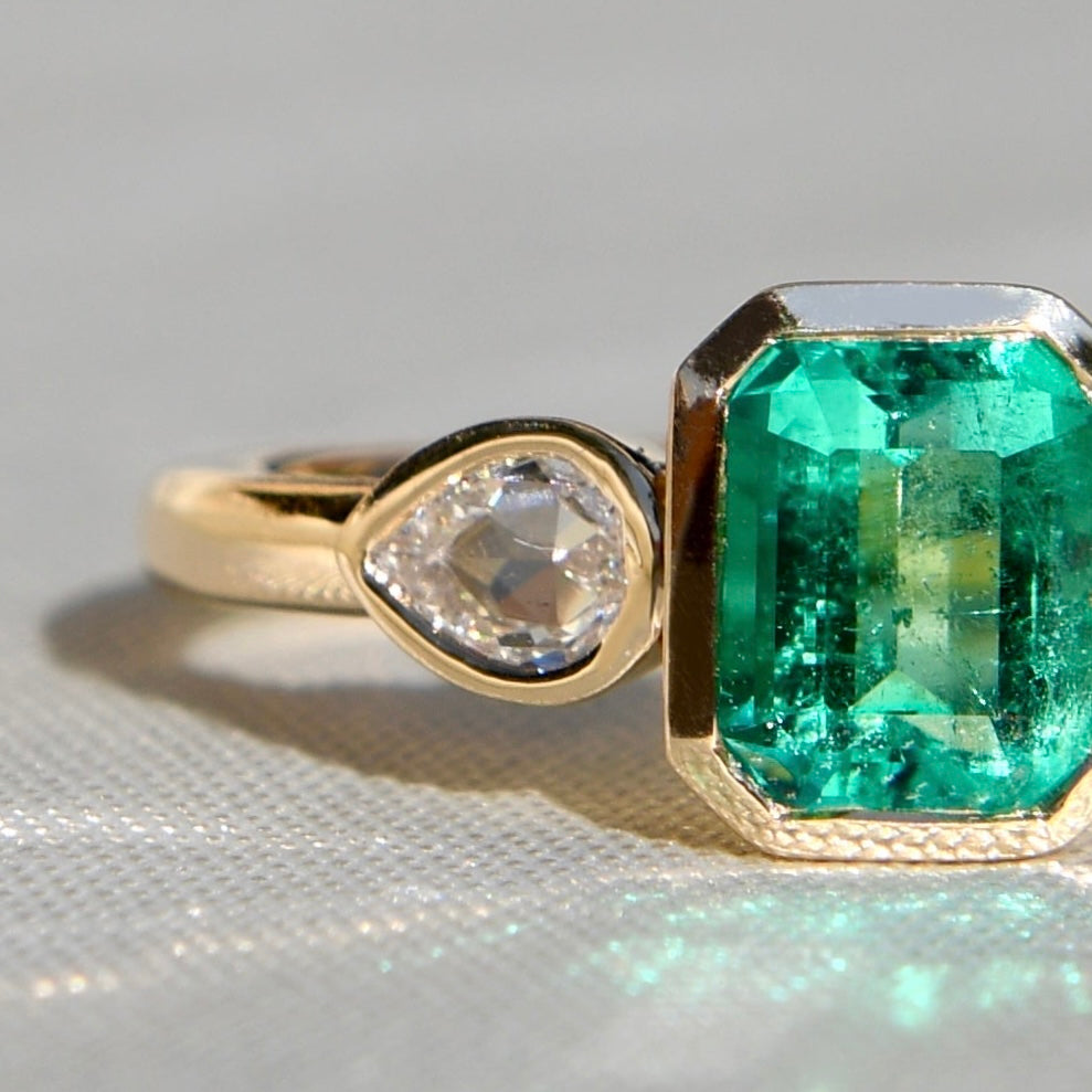 0.91 ct Colombian emerald and pear rose cut diamond three stone ring