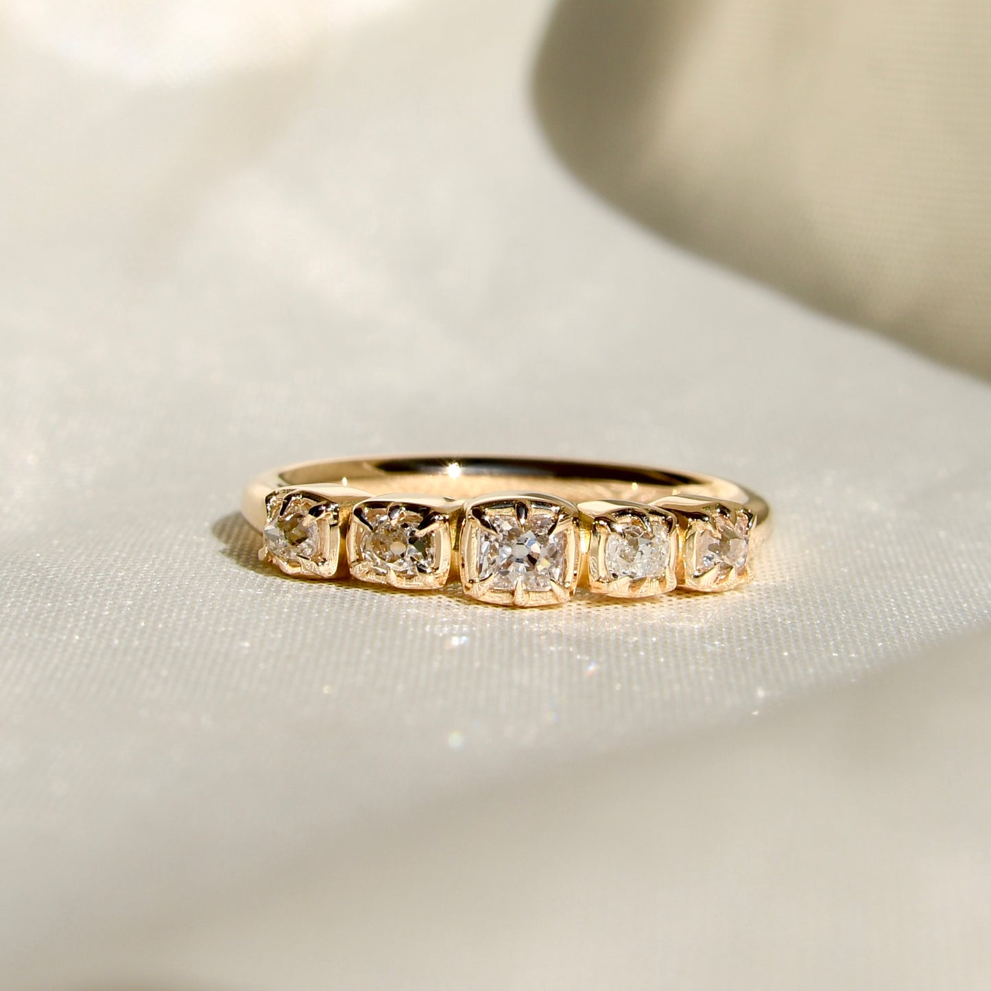 0.60 ct peruzzi cut diamond five stone band ring