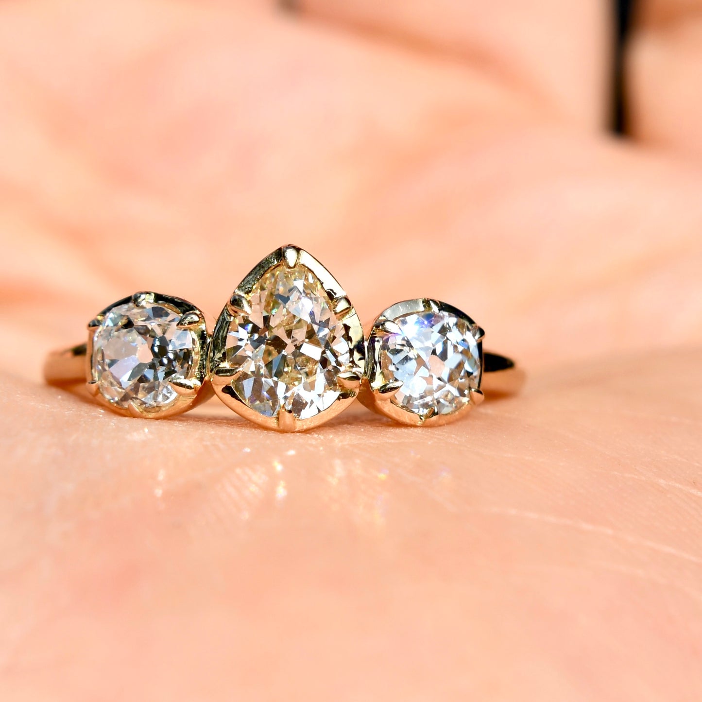 0.61 ct old pear and old mine cut diamond three stone ring