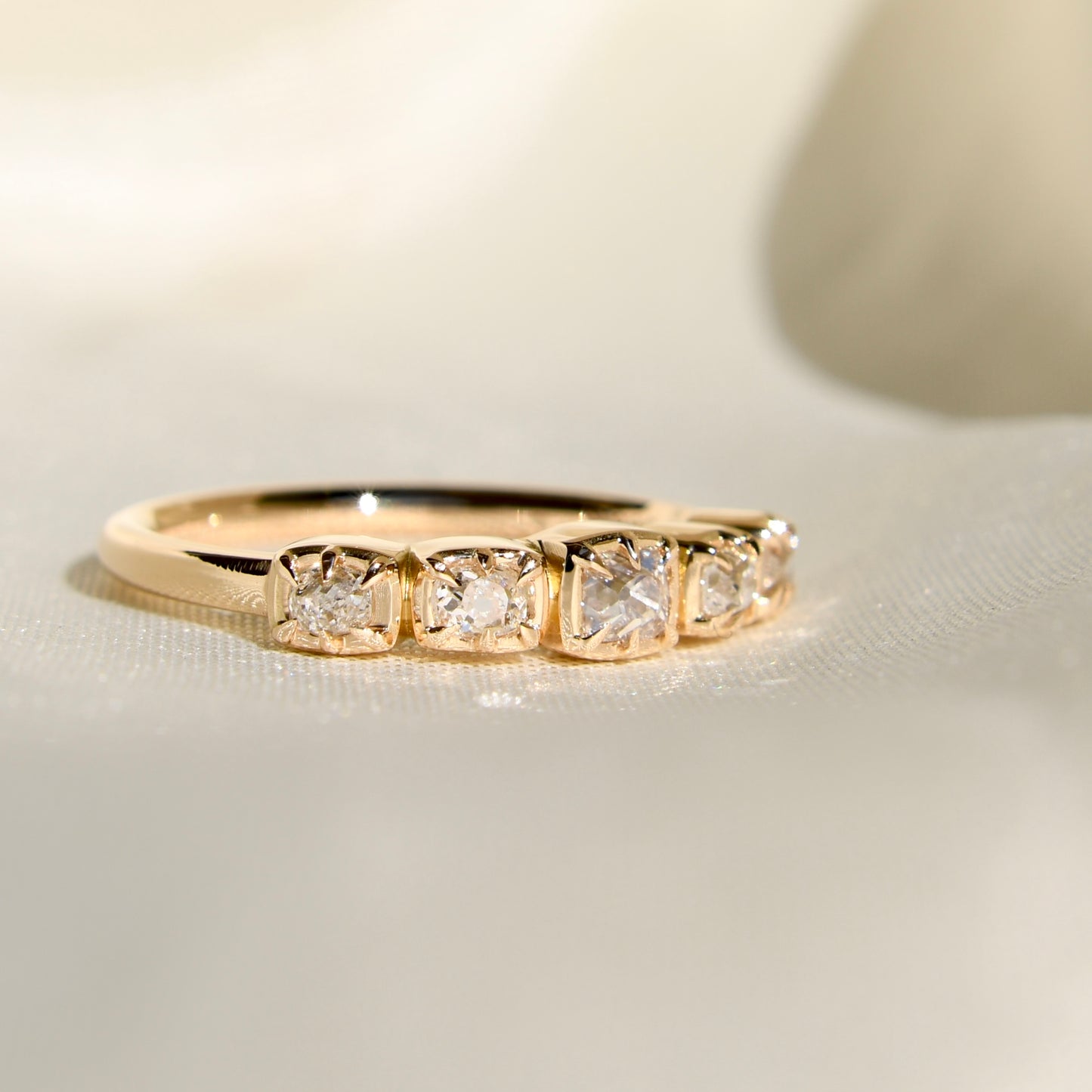 0.60 ct peruzzi cut diamond five stone band ring