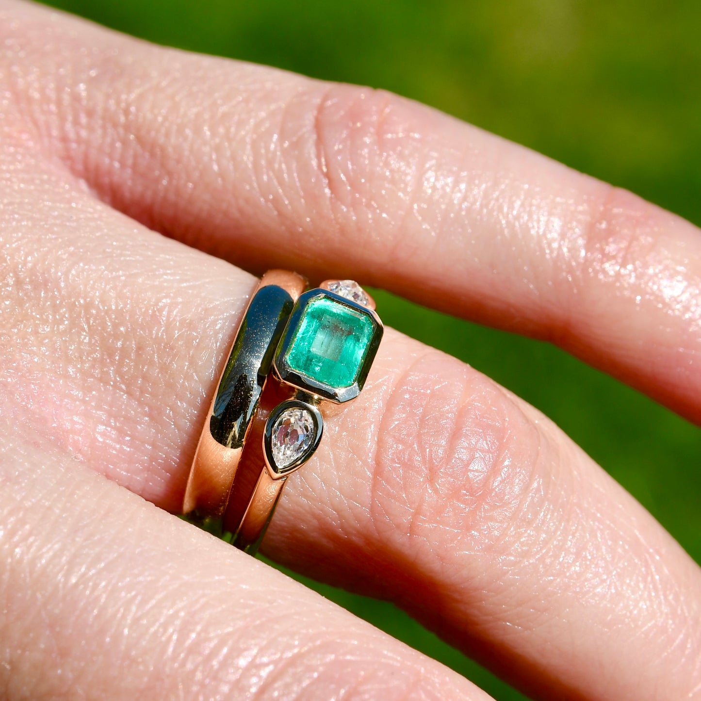 0.69 ct Colombian emerald and old pear cut diamond three stone ring