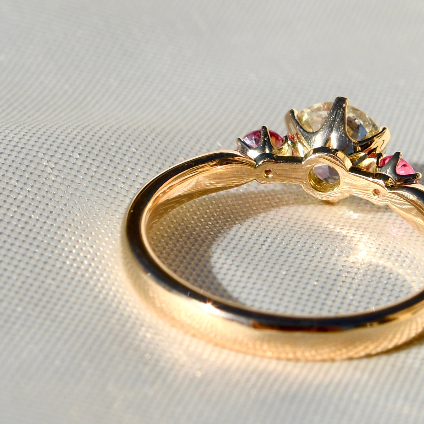 0.78 ct transitional cut diamond and spinel three stone ring