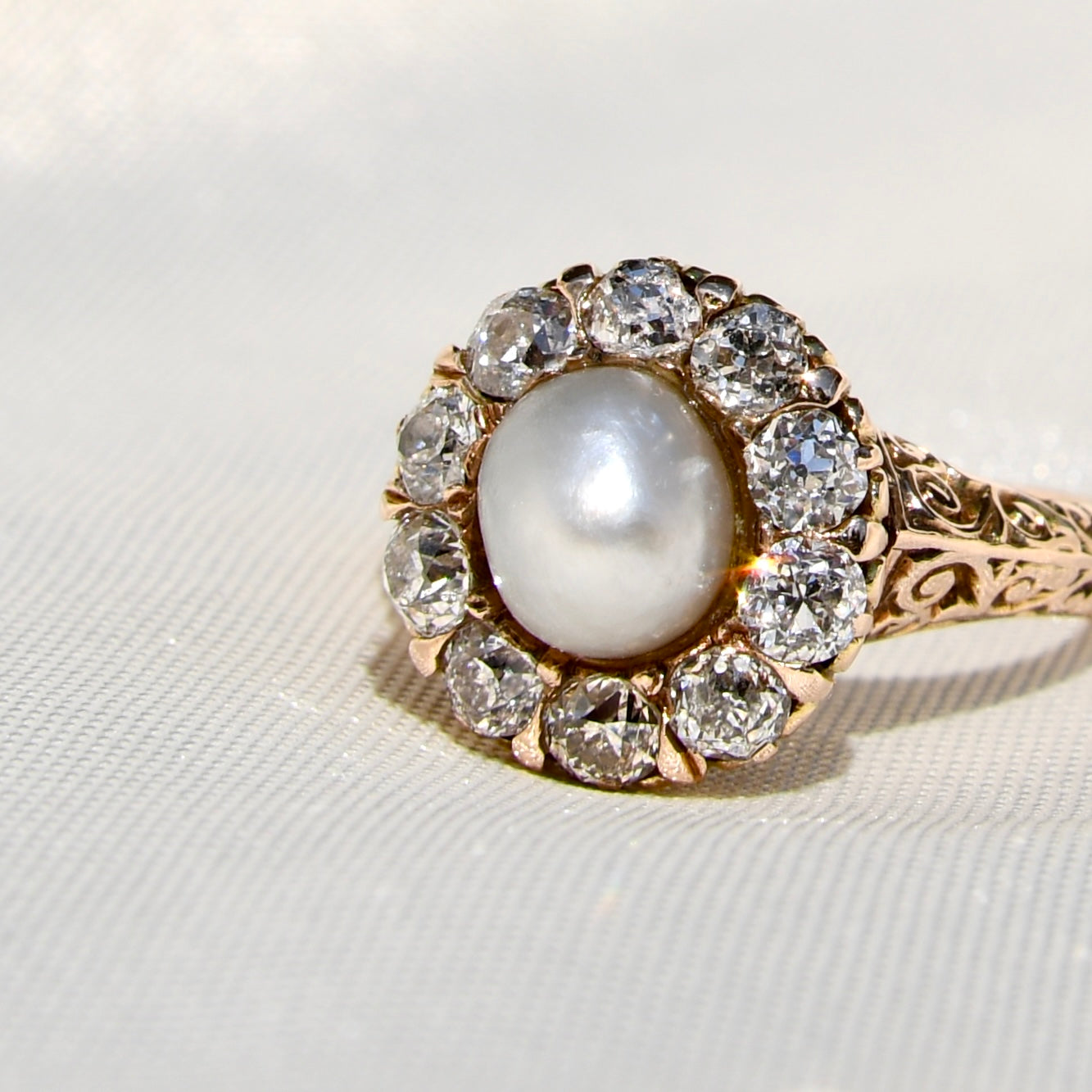Antique natural pearl and 1.20 ct old mine cut diamond daisy ring
