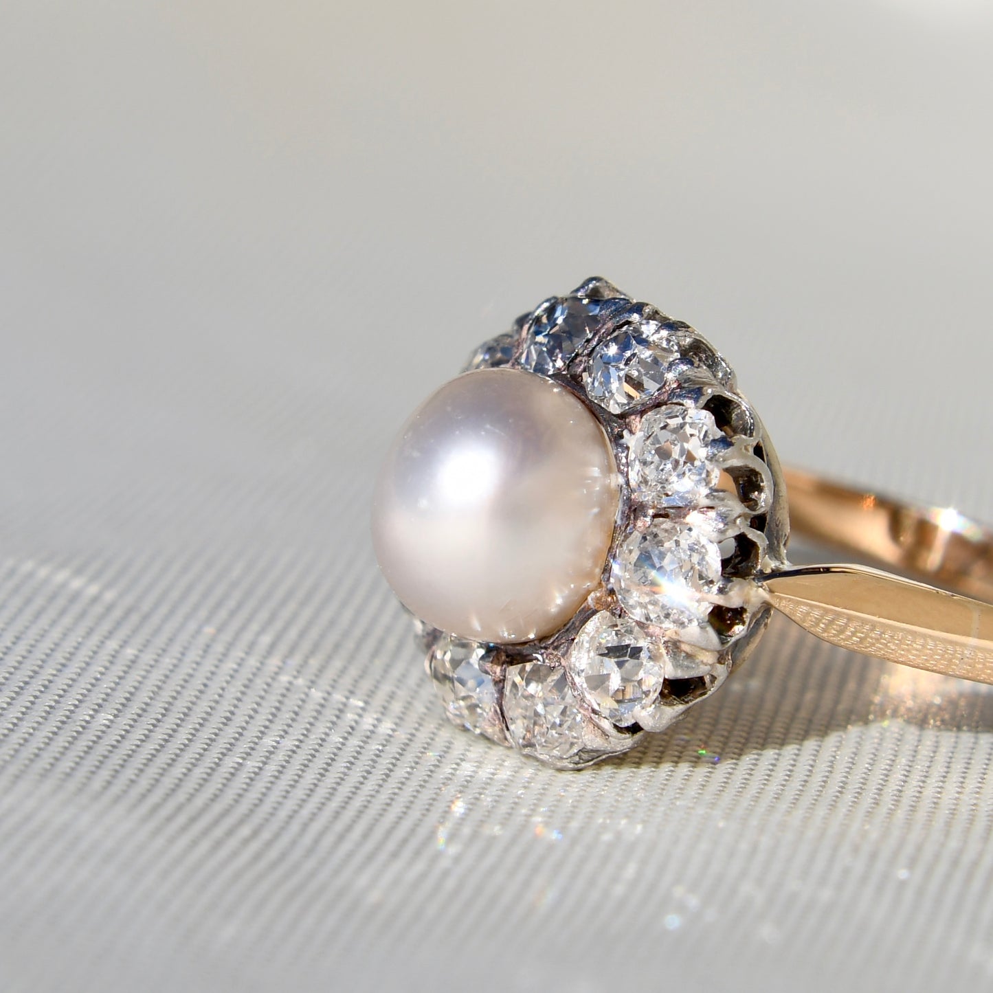 Antique natural pearl and 1.30 ct old mine cut diamond daisy ring