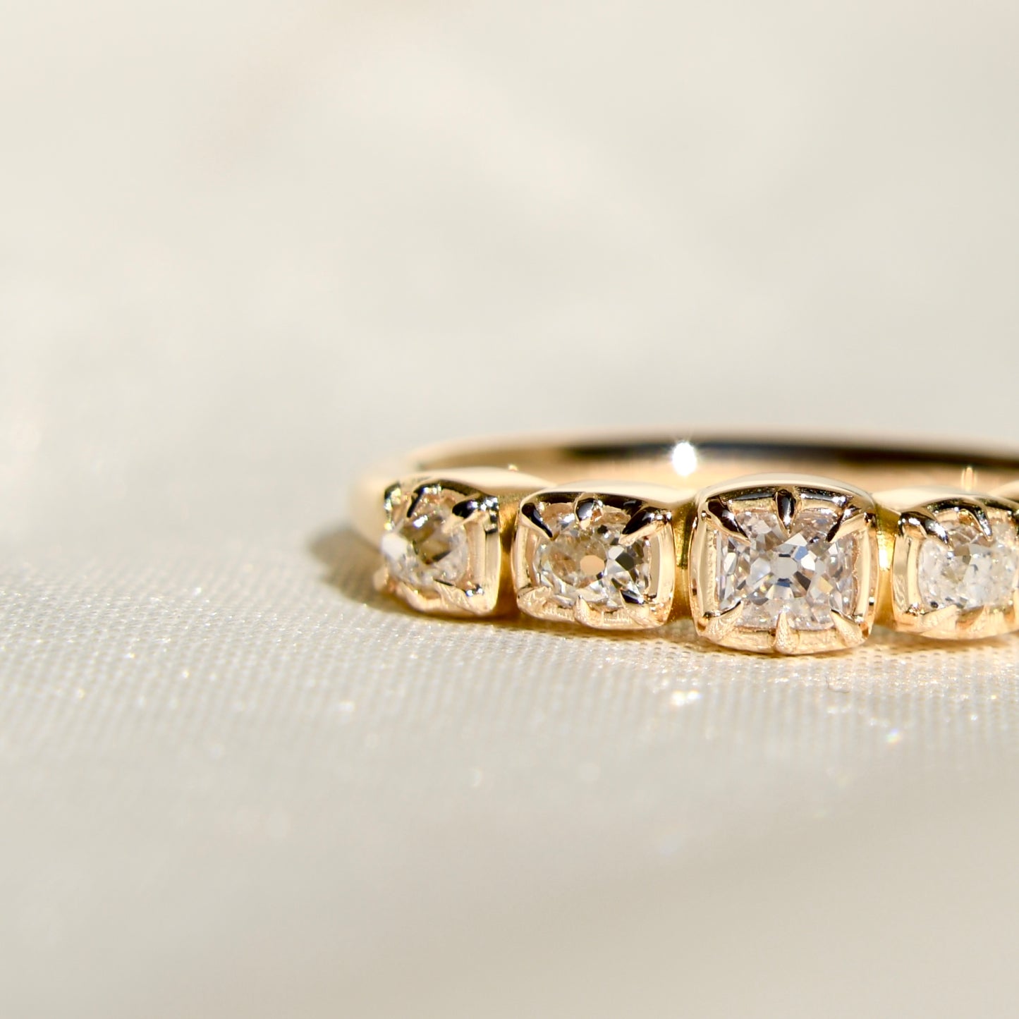 0.60 ct peruzzi cut diamond five stone band ring