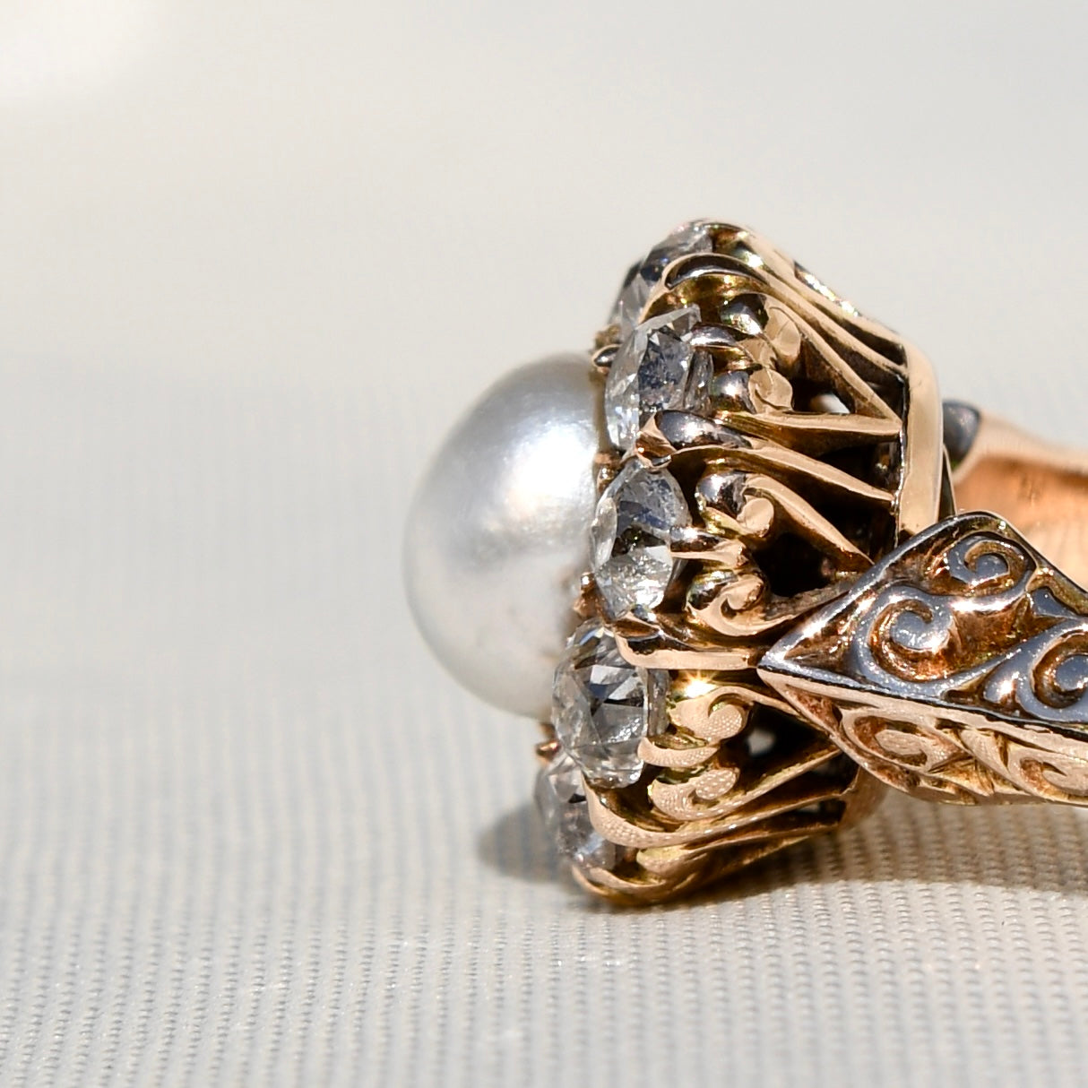 Antique natural pearl and 1.20 ct old mine cut diamond daisy ring