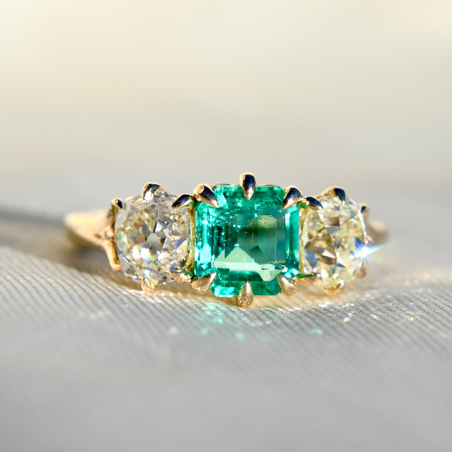 0.95 ct Colombian emerald and old mine cut diamond three stone ring