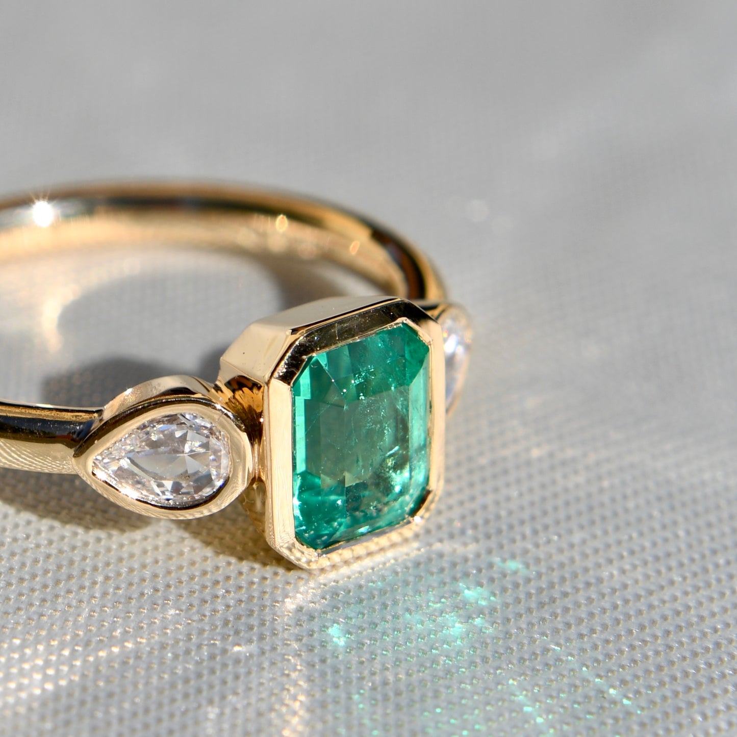 0.91 ct Colombian emerald and pear rose cut diamond three stone ring