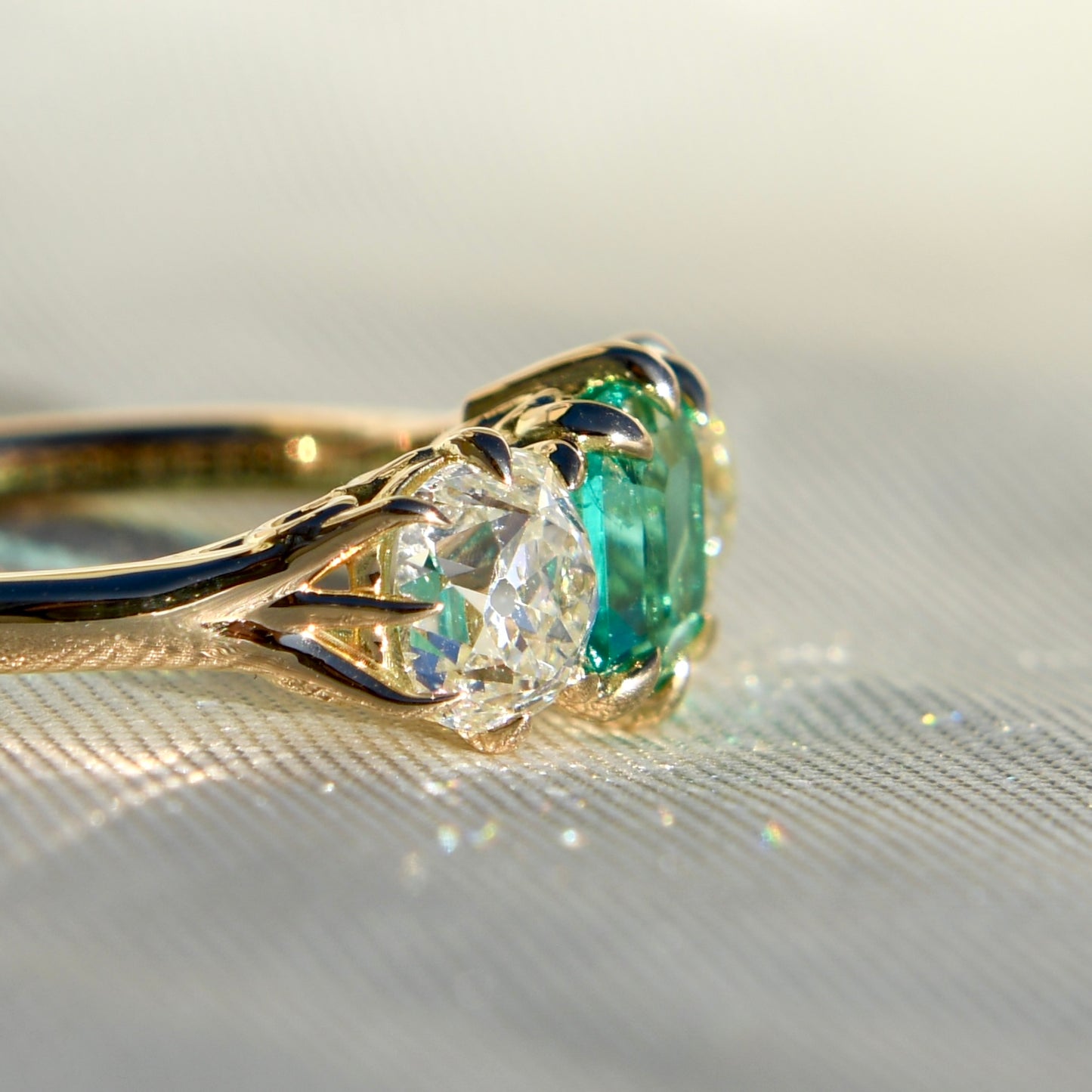 0.95 ct Colombian emerald and old mine cut diamond three stone ring