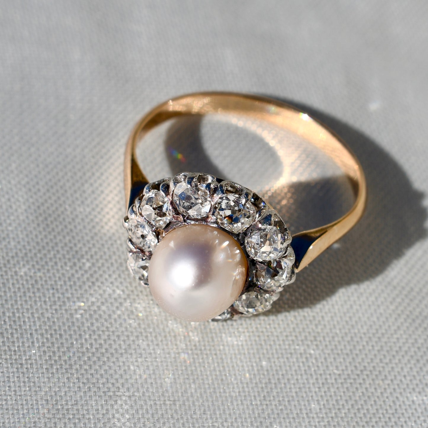 Antique natural pearl and 1.30 ct old mine cut diamond daisy ring