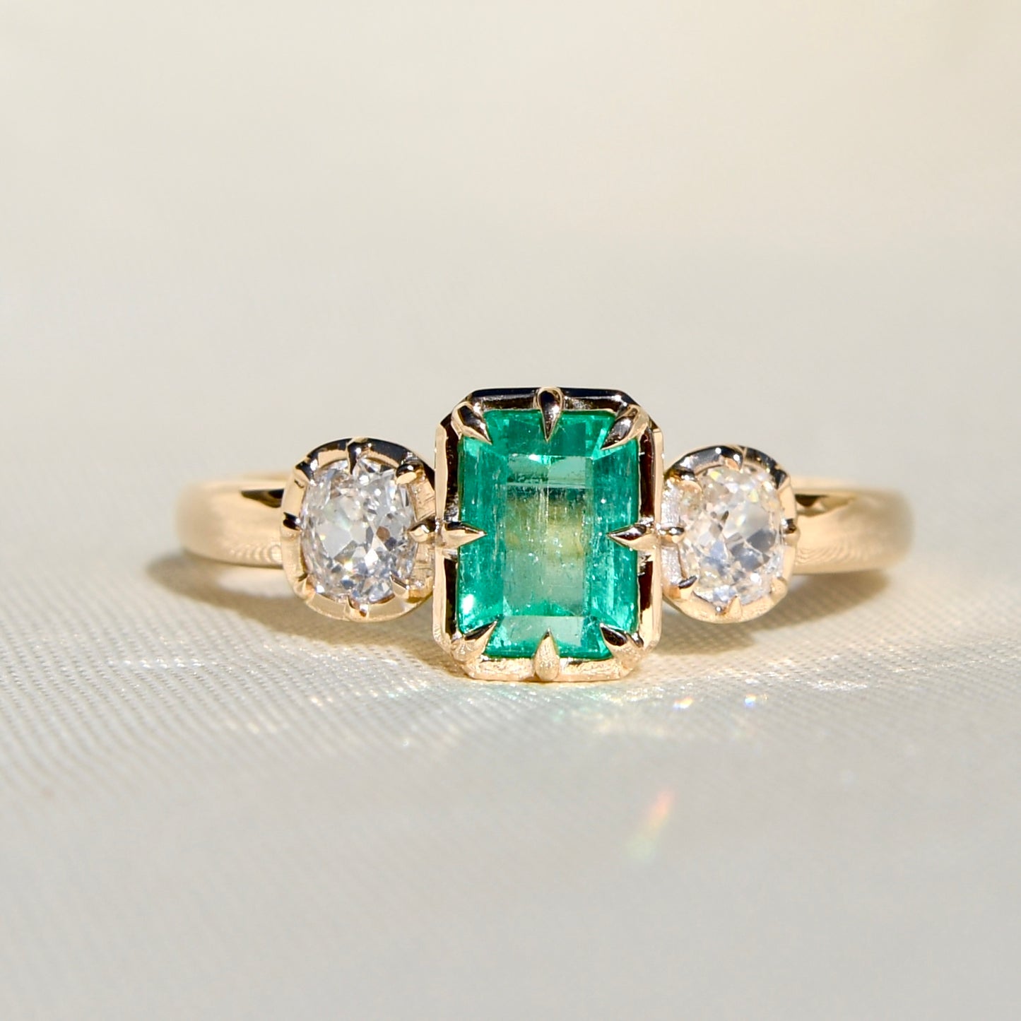0.93 ct Colombian emerald and old mine cut diamond three stone ring