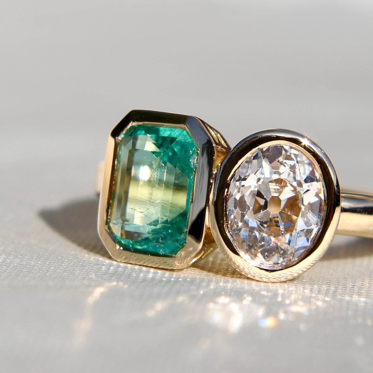 1.02 ct Colombian emerald and oval old mine cut diamond Toi et Moi ring