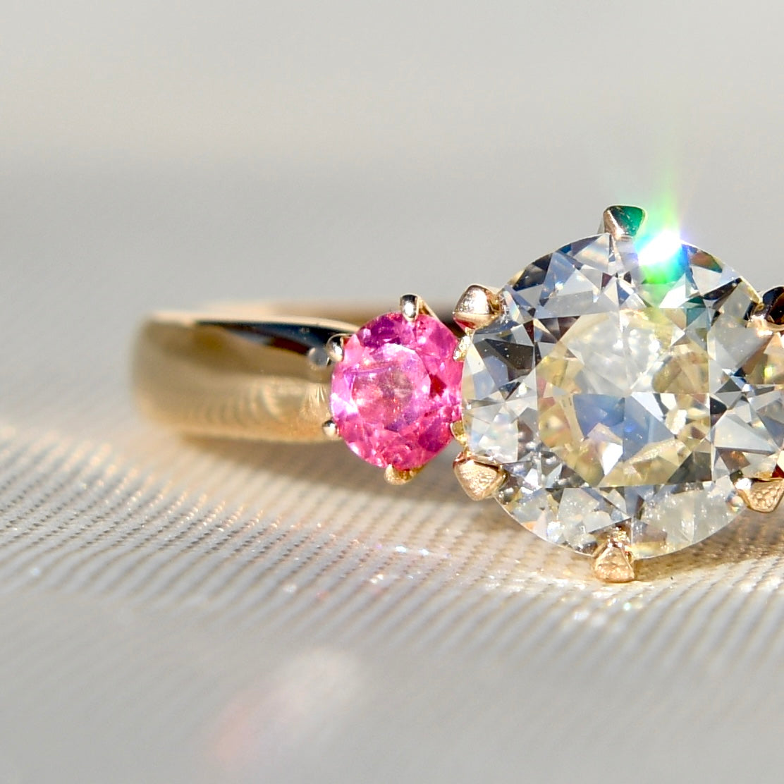 0.78 ct transitional cut diamond and spinel three stone ring