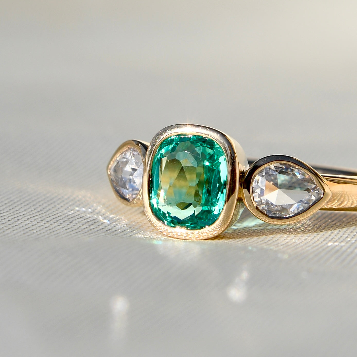 0.80 ct Colombian emerald and pear rose cut diamond three stone ring