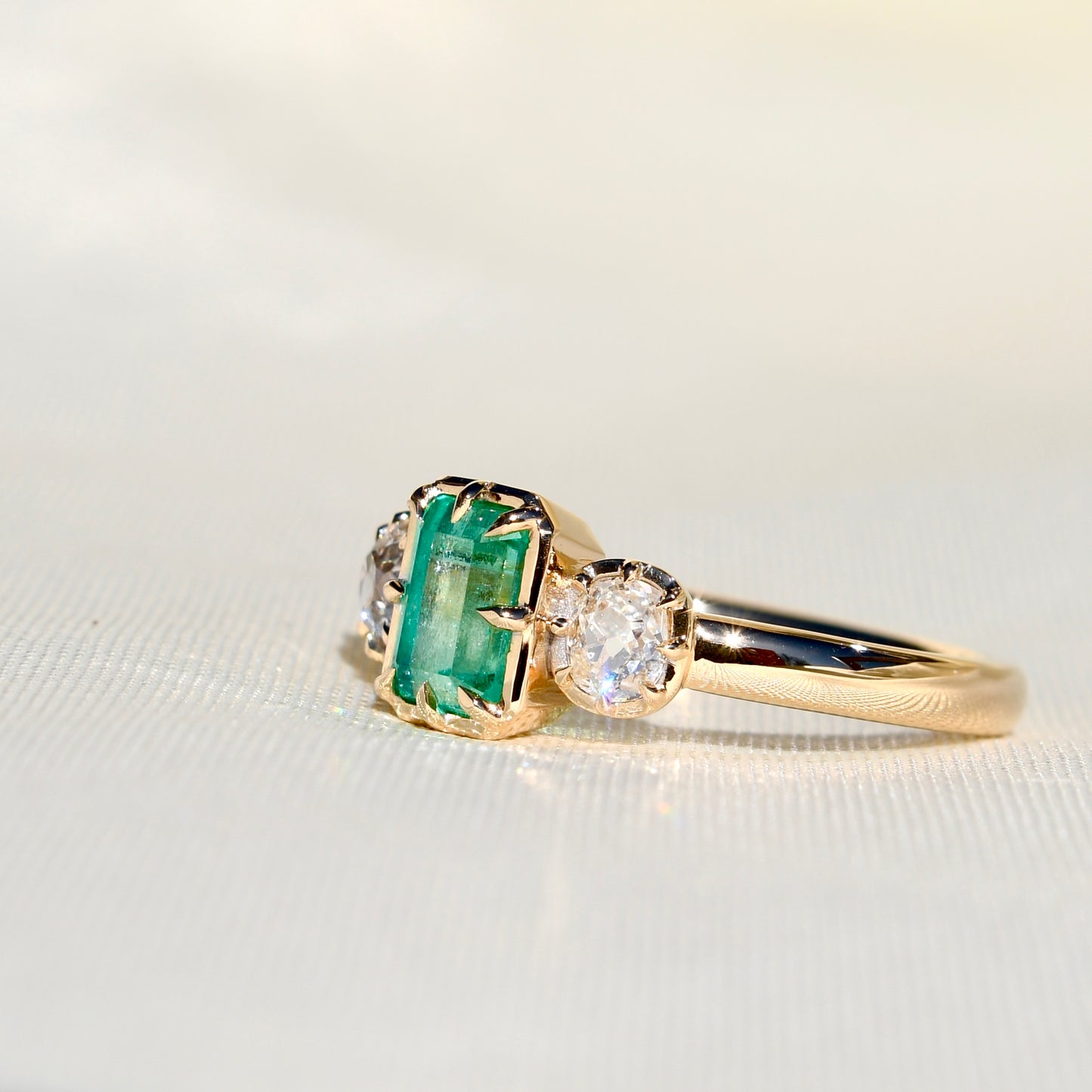 0.93 ct Colombian emerald and old mine cut diamond three stone ring