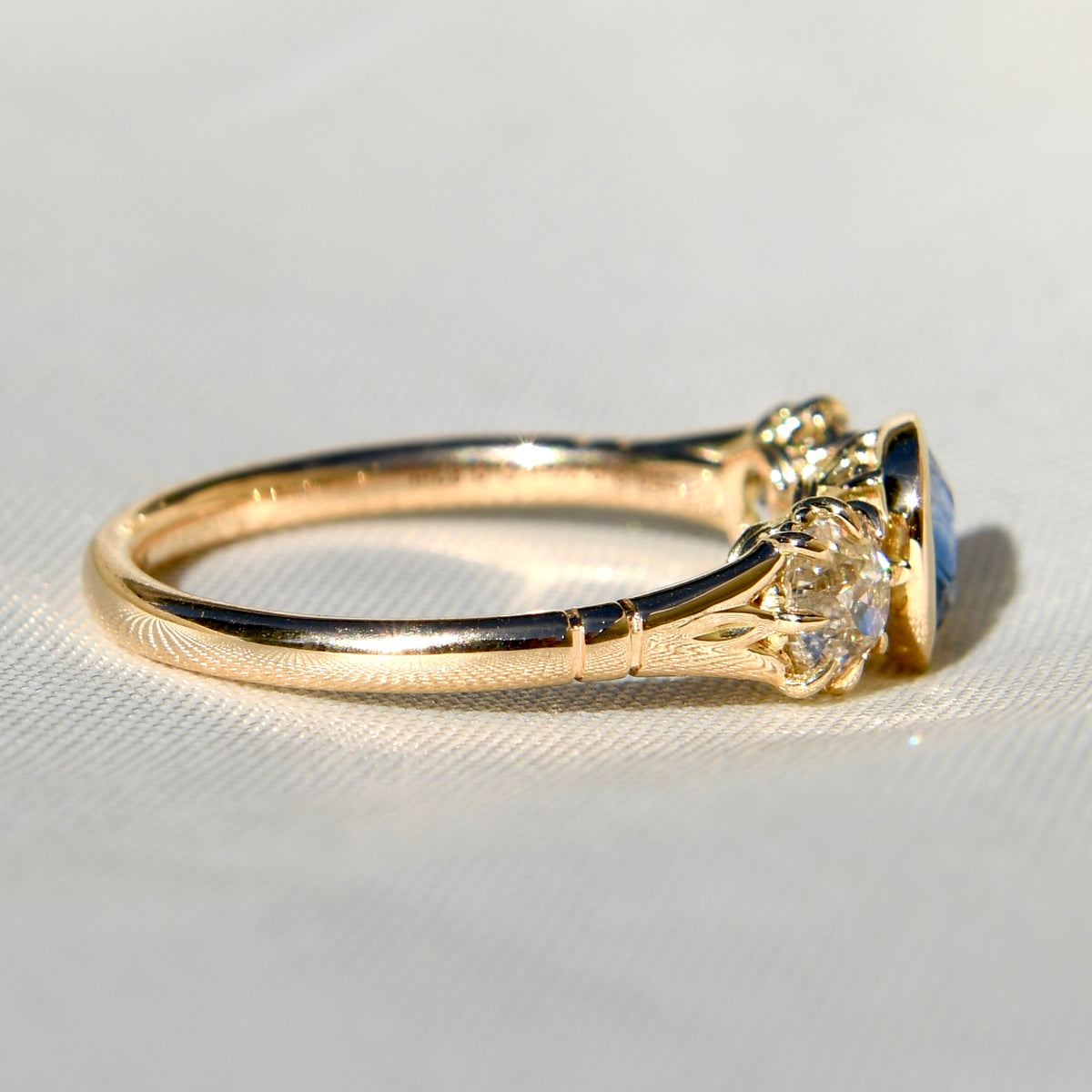 0.75 ct Ceylon sapphire and old mine cut diamond three stone ring