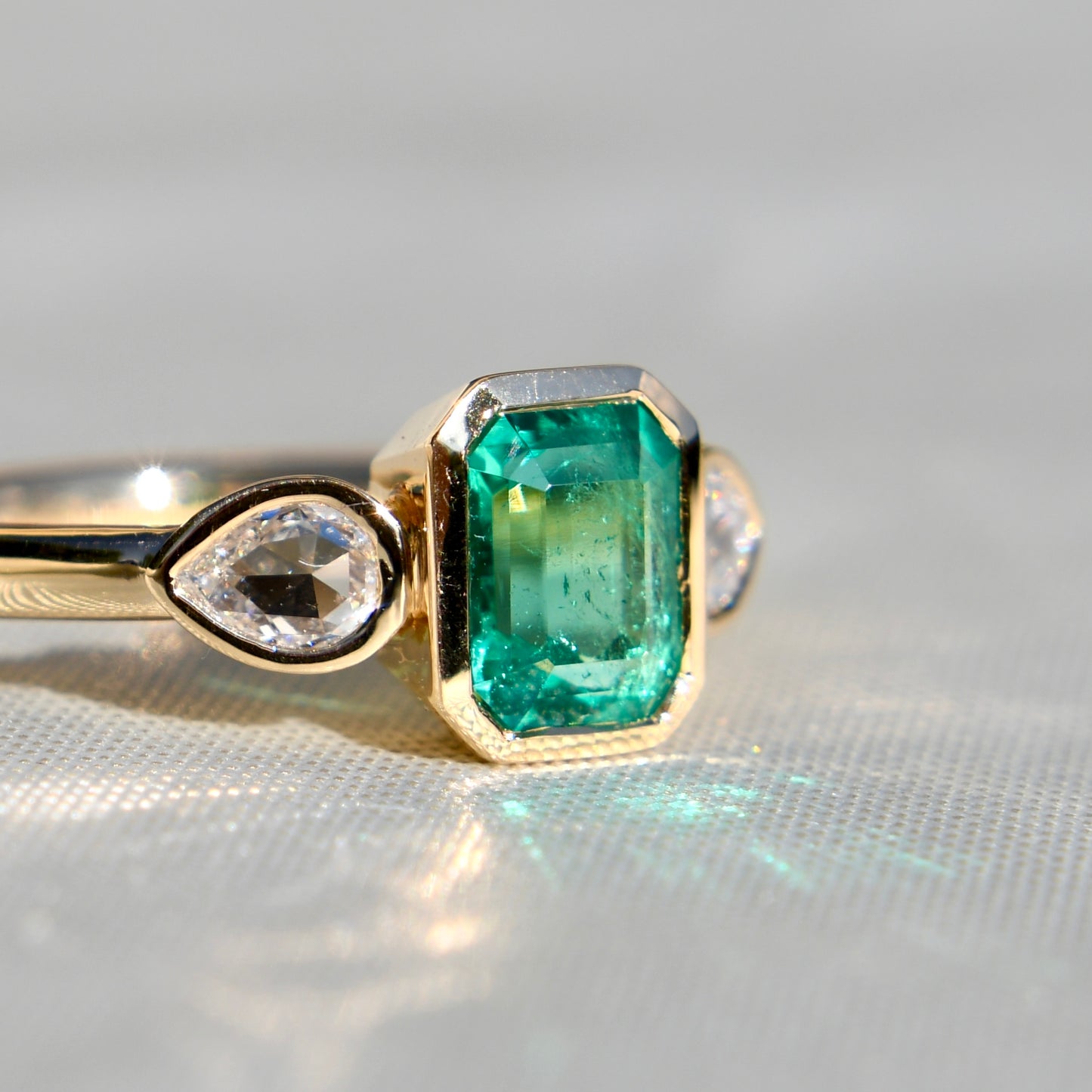 0.91 ct Colombian emerald and pear rose cut diamond three stone ring