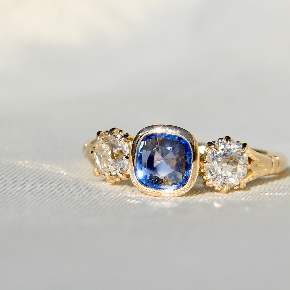 0.75 ct Ceylon sapphire and old mine cut diamond three stone ring