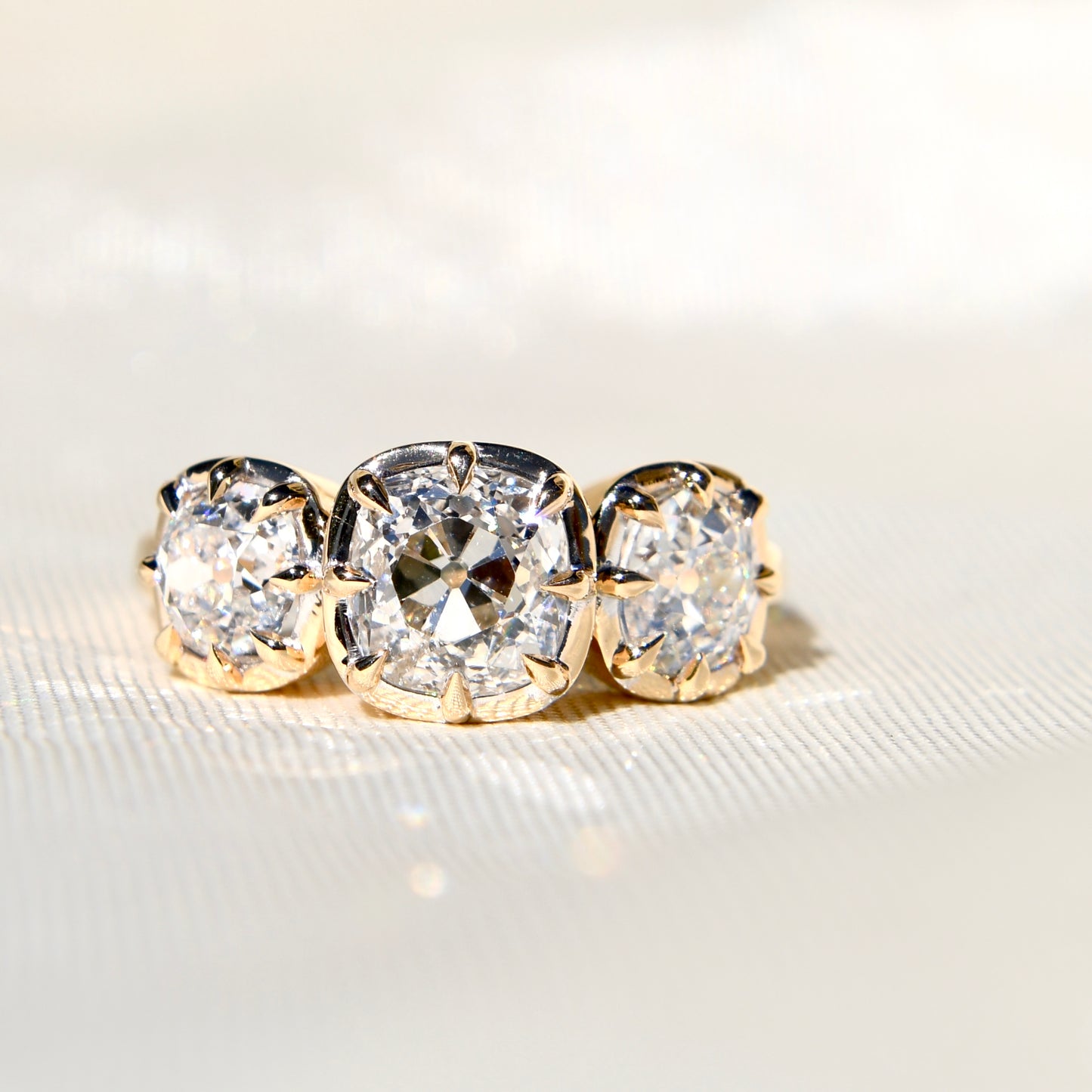 3.35 ct old mine cut diamond three stone ring