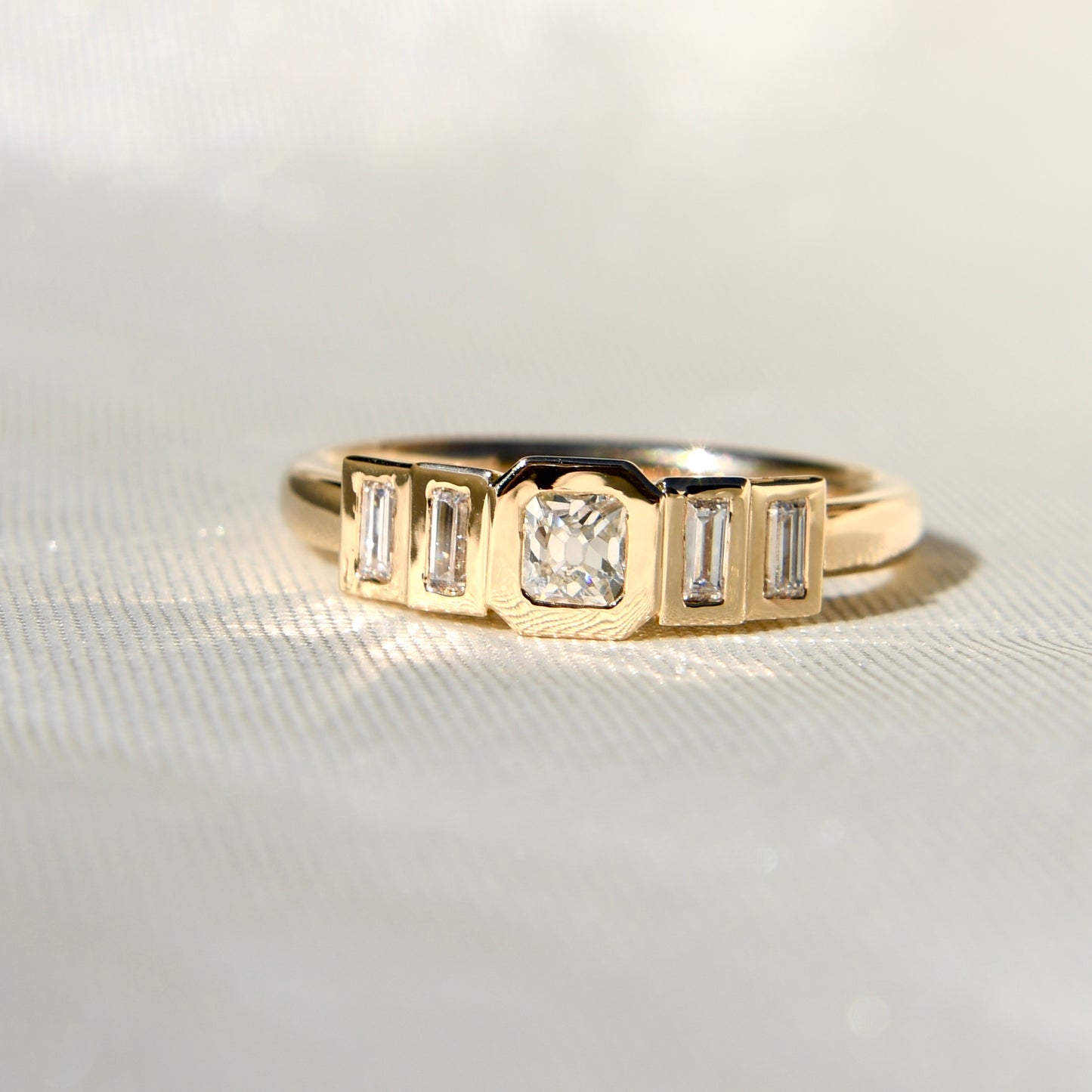 0.23 ct peruzzi and baguette cut diamond five stone ring