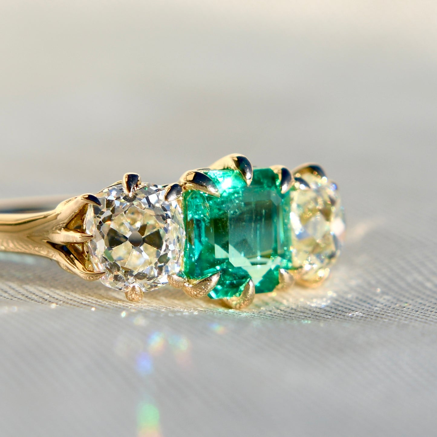 0.95 ct Colombian emerald and old mine cut diamond three stone ring
