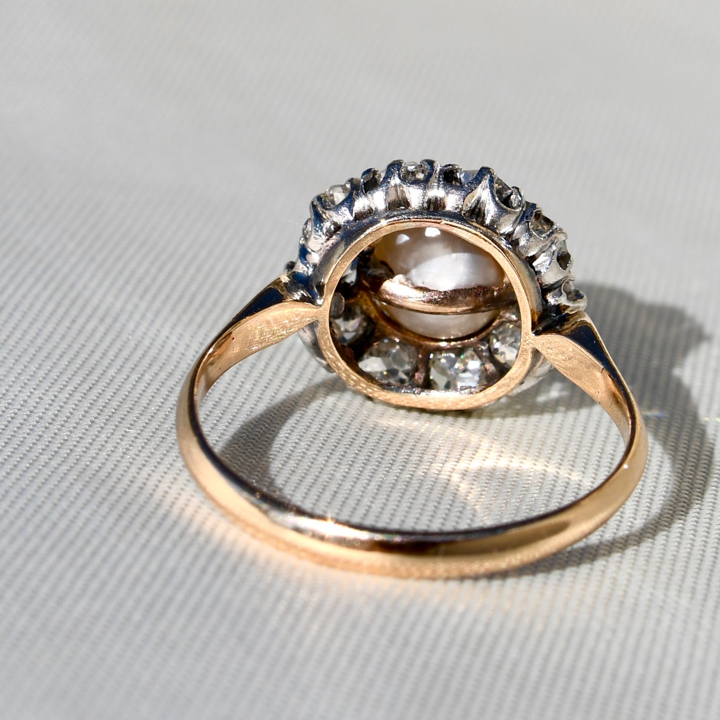Antique natural pearl and 1.30 ct old mine cut diamond daisy ring