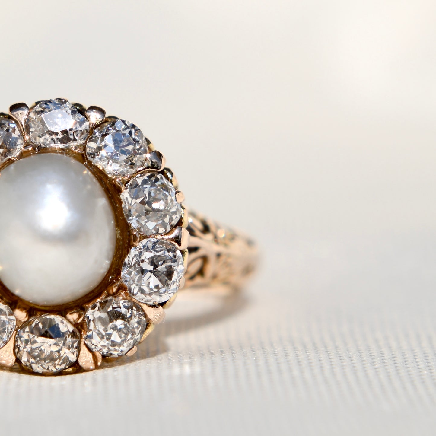 Antique natural pearl and 1.20 ct old mine cut diamond daisy ring
