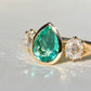 1.34 ct Colombian pear cut emerald and old mine cut diamond three stone ring