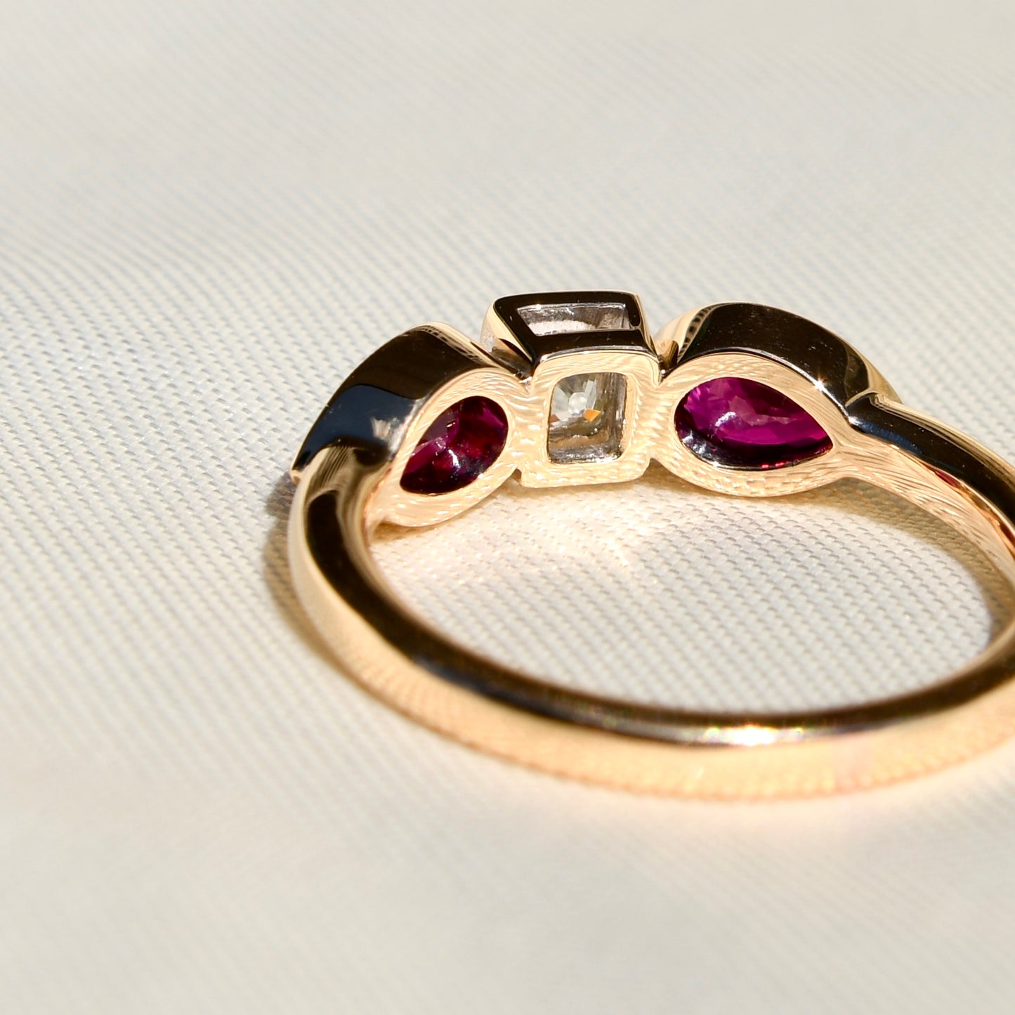 0.30 ct peruzzi cut diamond and pear ruby three stone ring