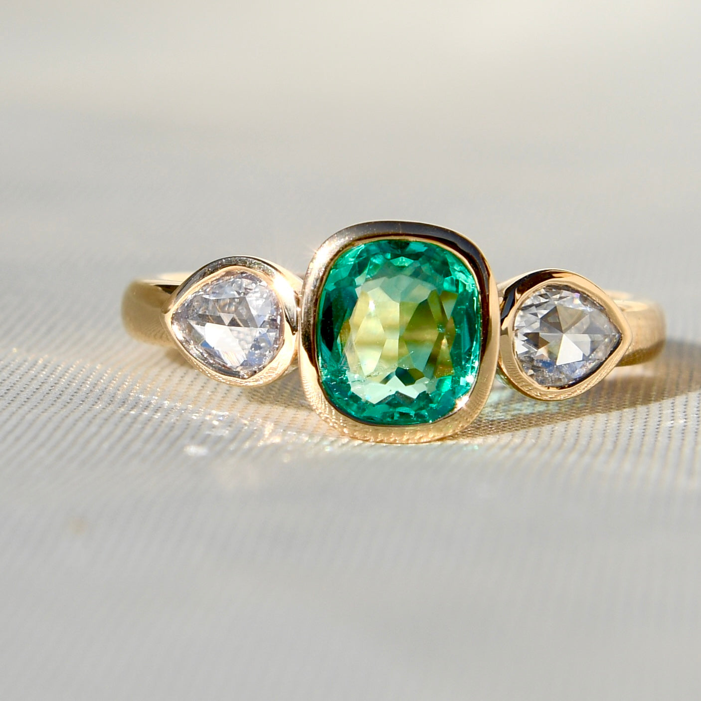 0.80 ct Colombian emerald and pear rose cut diamond three stone ring