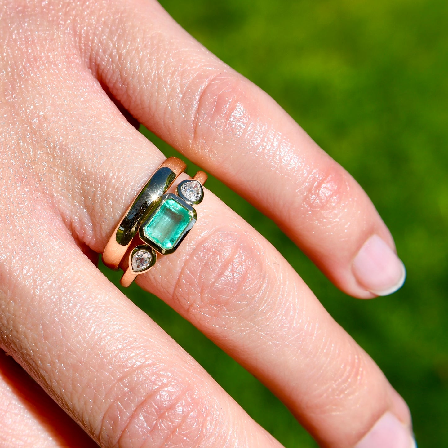 0.69 ct Colombian emerald and old pear cut diamond three stone ring