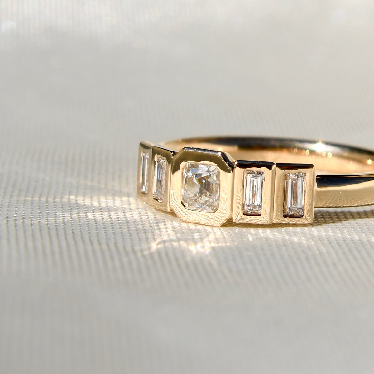 0.23 ct peruzzi and baguette cut diamond five stone ring