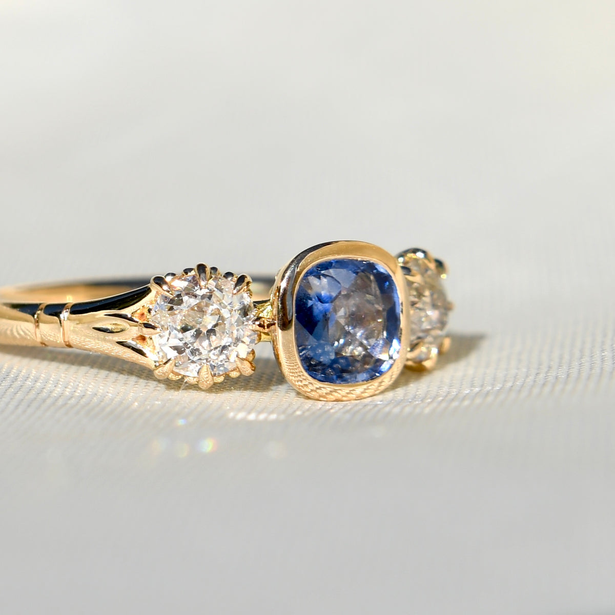 0.75 ct Ceylon sapphire and old mine cut diamond three stone ring
