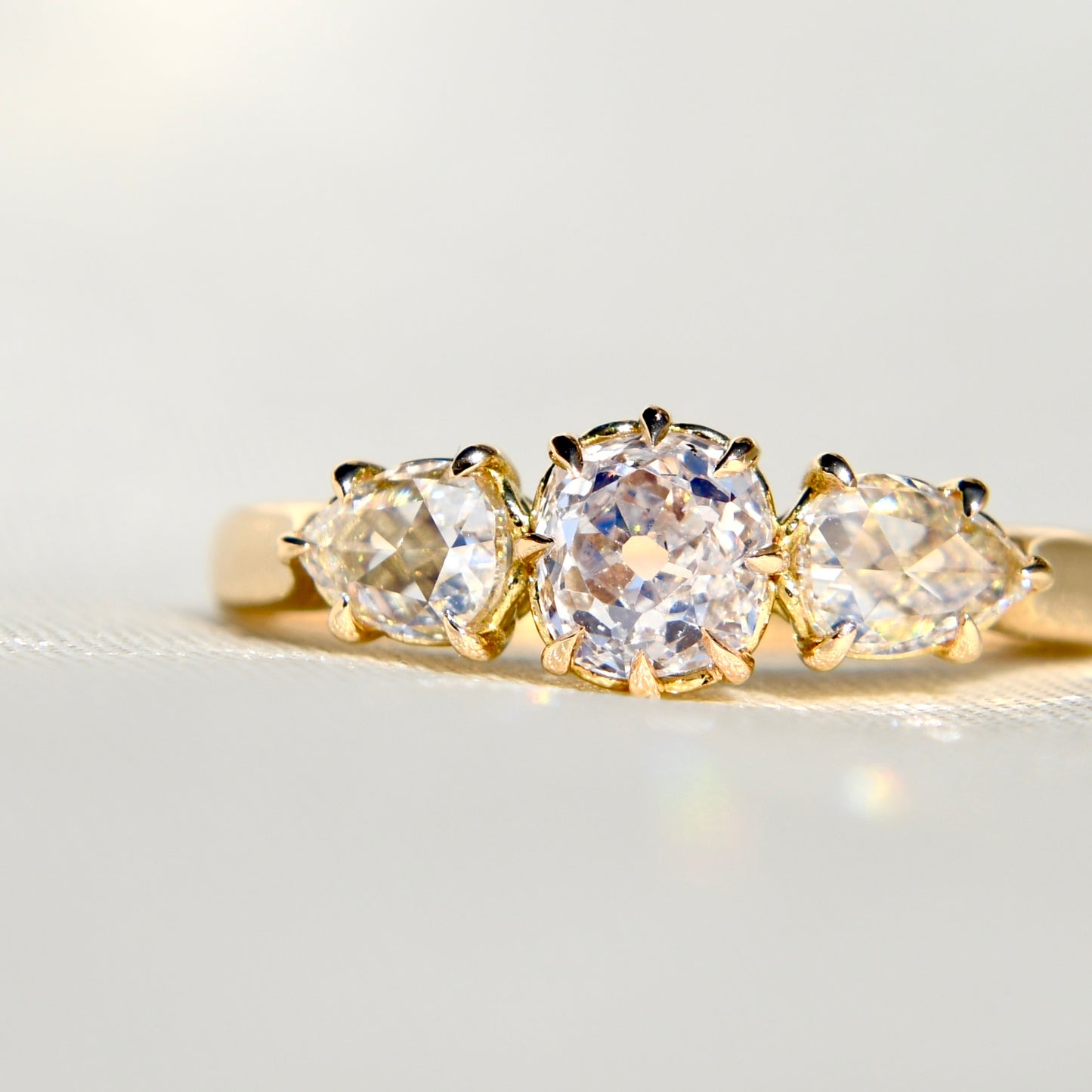 0.63 ct old mine and pear rose cut diamond three stone ring