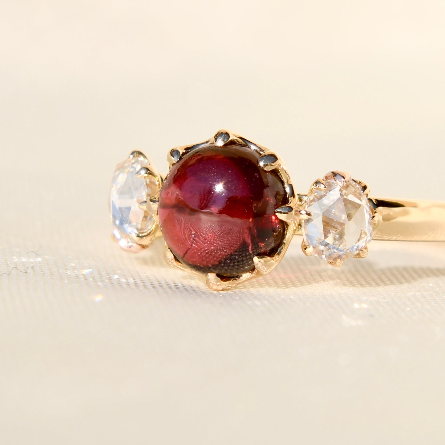 2.15 ct tourmaline cabochon and rose cut diamond three stone ring