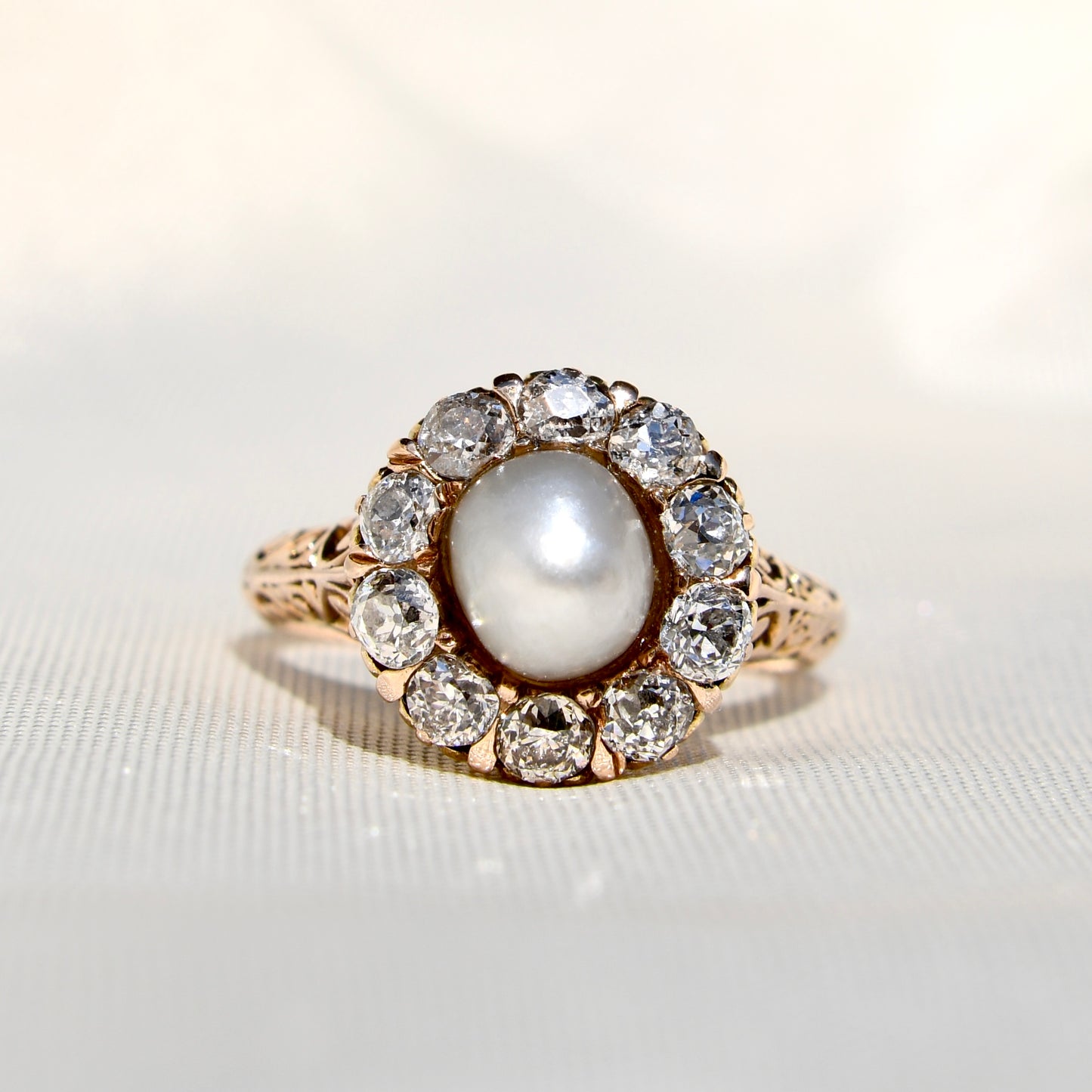 Antique natural pearl and 1.20 ct old mine cut diamond daisy ring