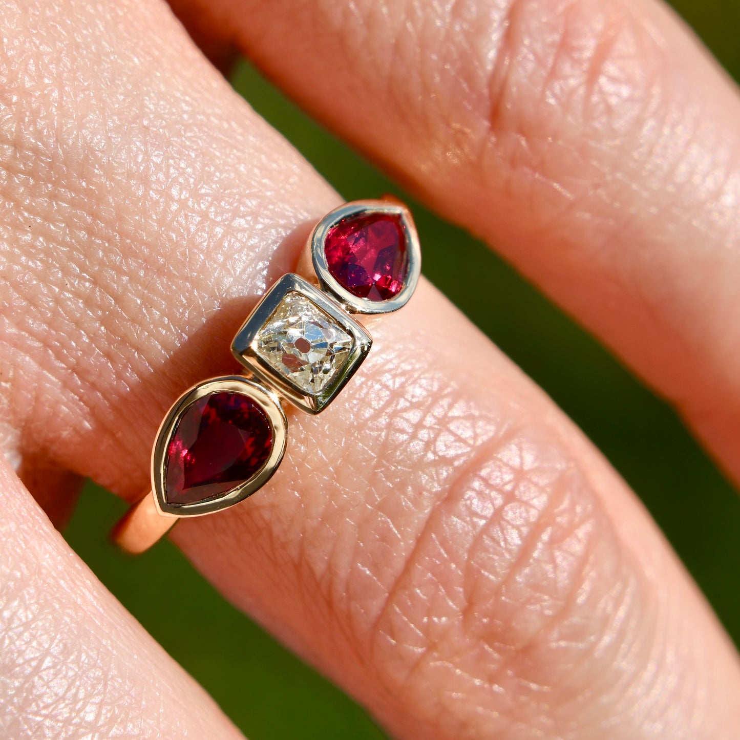 0.30 ct peruzzi cut diamond and pear ruby three stone ring