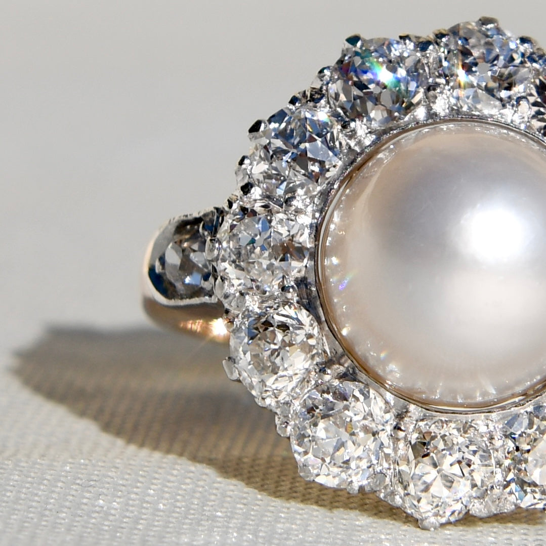 Antique Belle Époque natural pearl and 1.74 ct old European cut diamond daisy ring