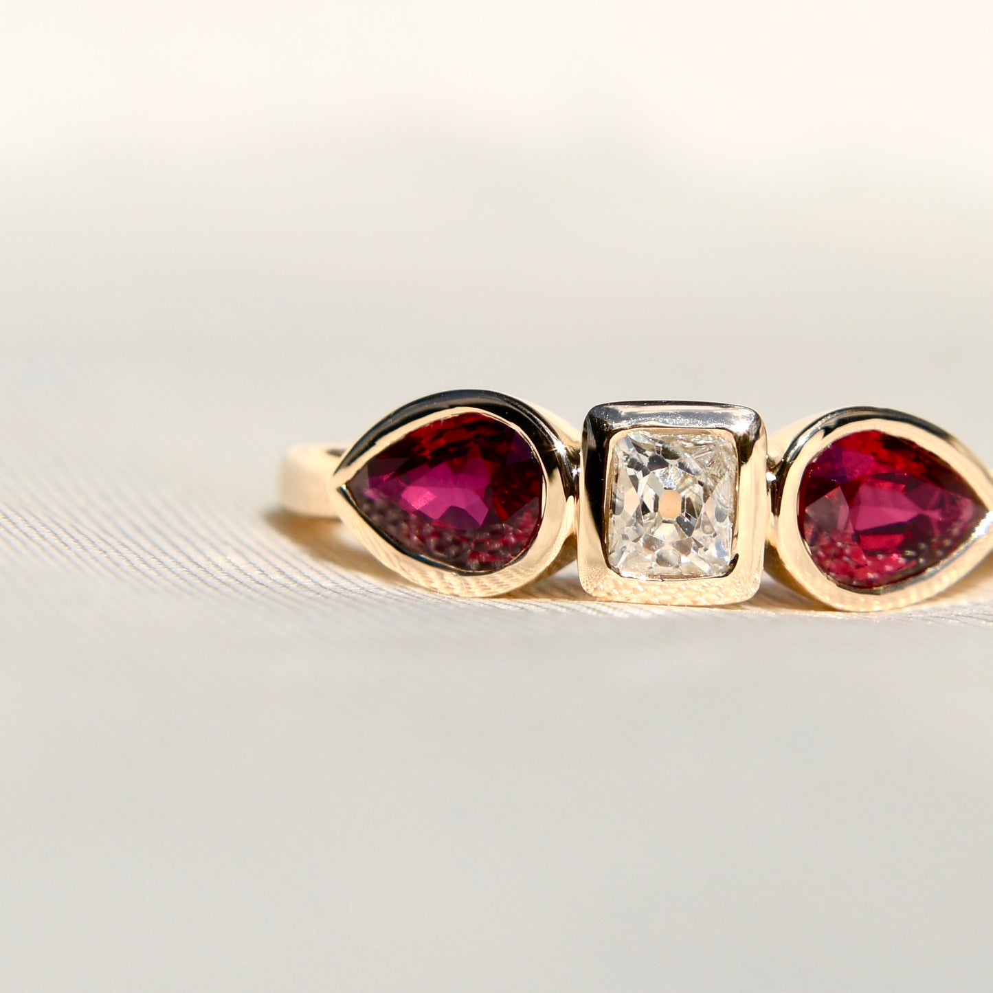 0.30 ct peruzzi cut diamond and pear ruby three stone ring