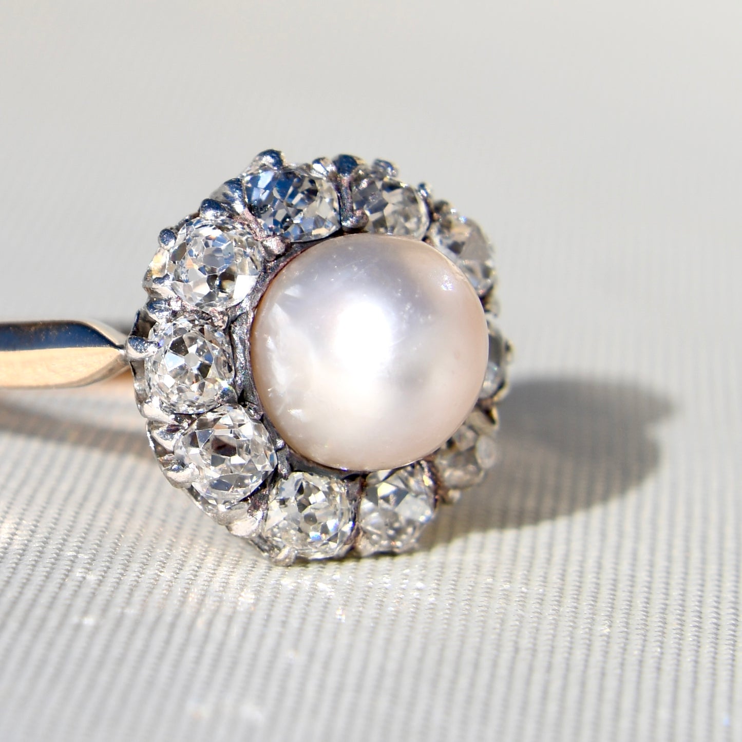 Antique natural pearl and 1.30 ct old mine cut diamond daisy ring