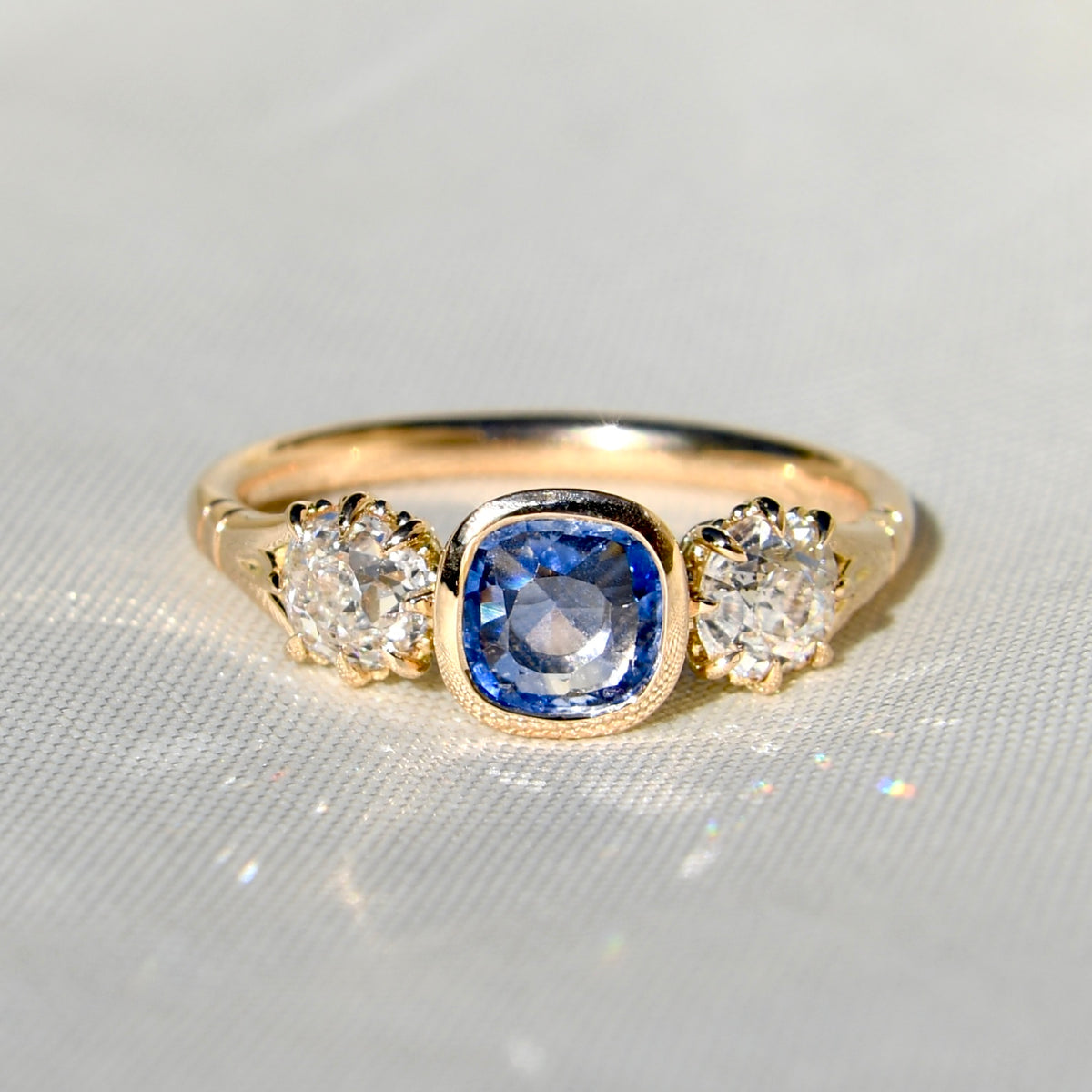 0.75 ct Ceylon sapphire and old mine cut diamond three stone ring