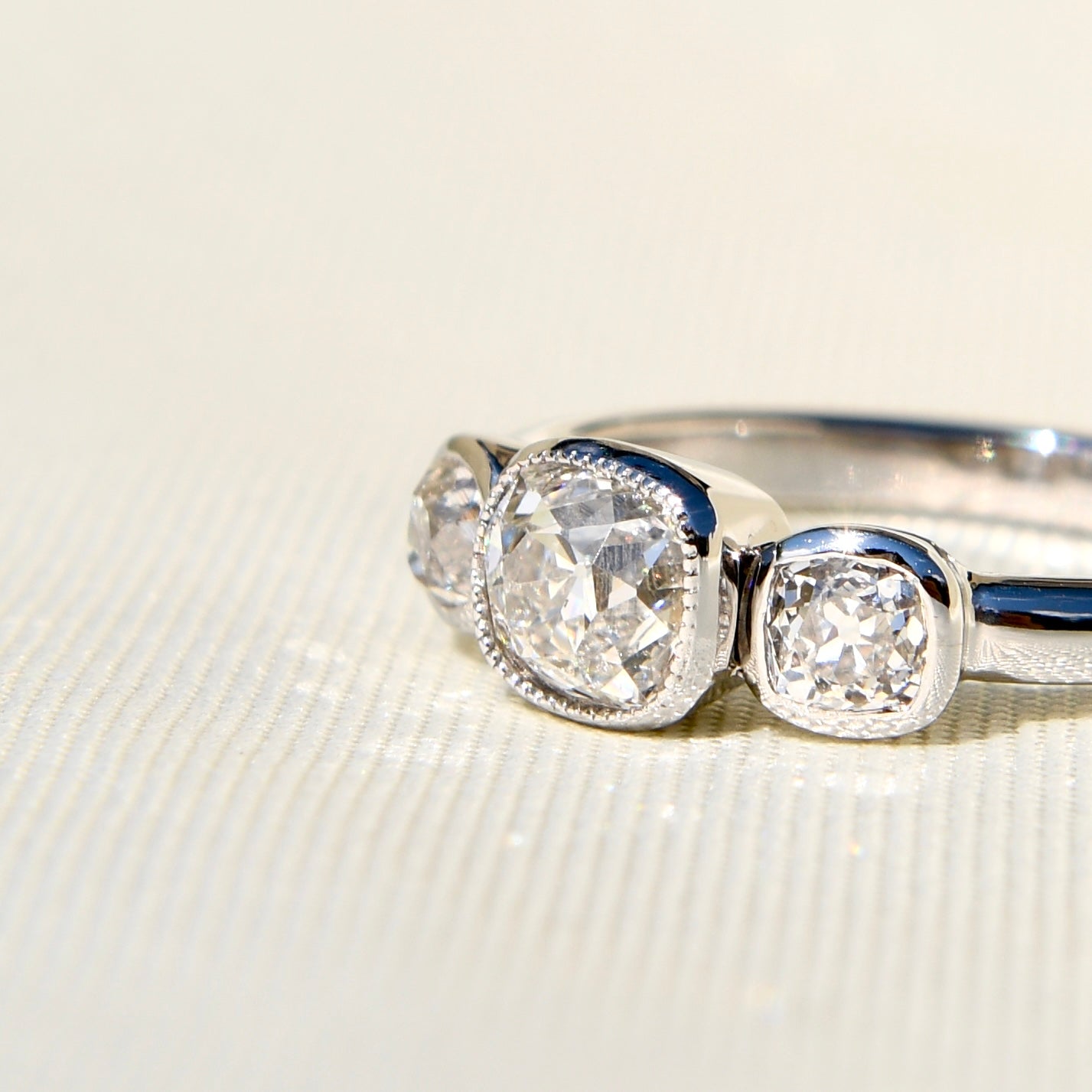 0.70 ct old mine cut diamond three stone ring