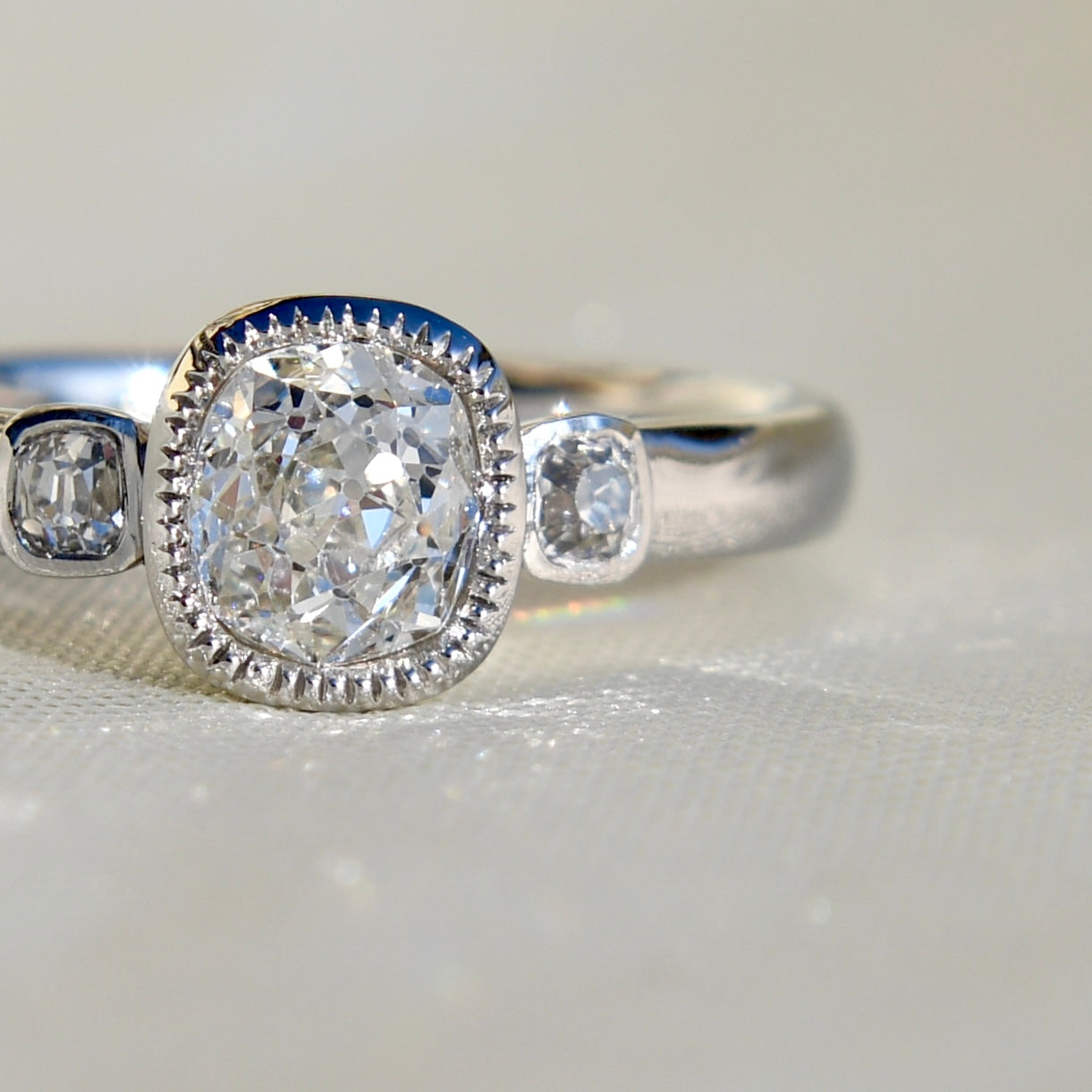 0.60 ct old mine and peruzzi cut diamond three stone ring