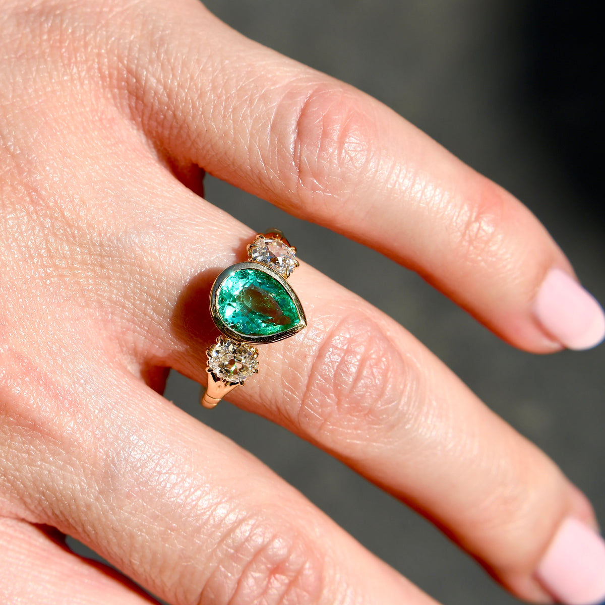 1.34 ct Colombian pear cut emerald and old mine cut diamond three stone ring