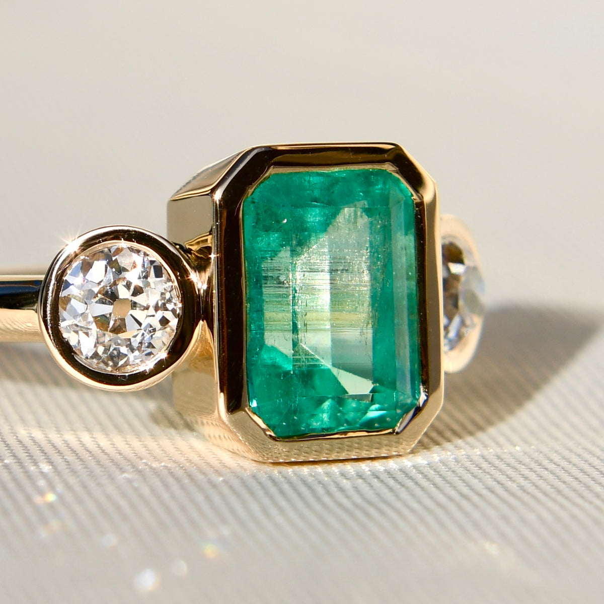 2.65 ct Colombian emerald and old mine cut diamond three stone ring