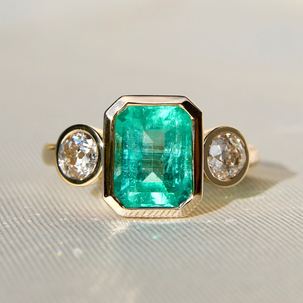 2.65 ct Colombian emerald and old mine cut diamond three stone ring