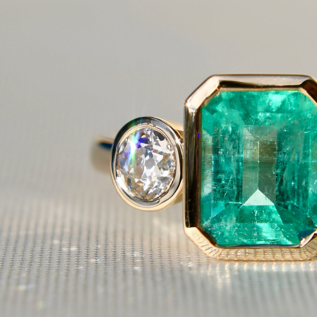 2.65 ct Colombian emerald and old mine cut diamond three stone ring