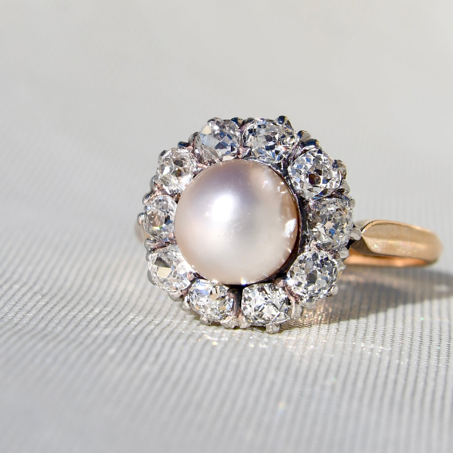 Antique natural pearl and 1.30 ct old mine cut diamond daisy ring