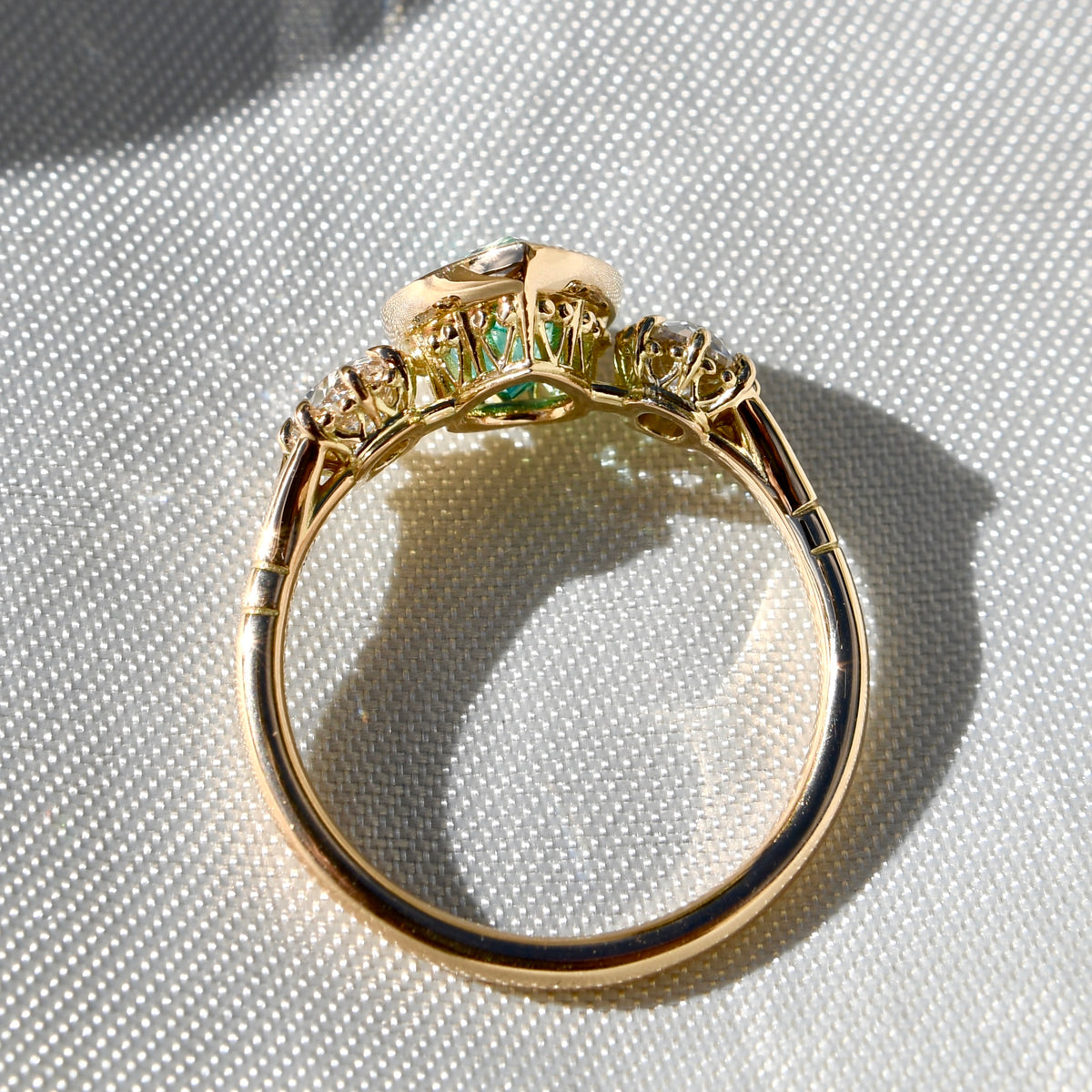 1.34 ct Colombian pear cut emerald and old mine cut diamond three stone ring