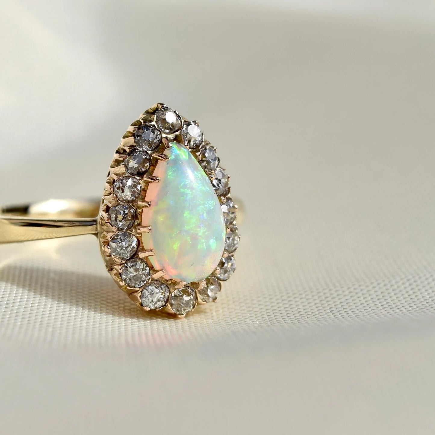 Opal pear and 0.32ct old mine cut diamond ring